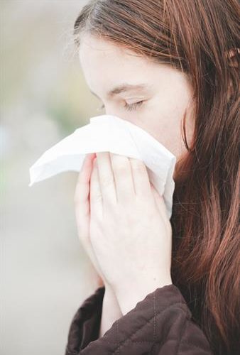 girl blowing nose